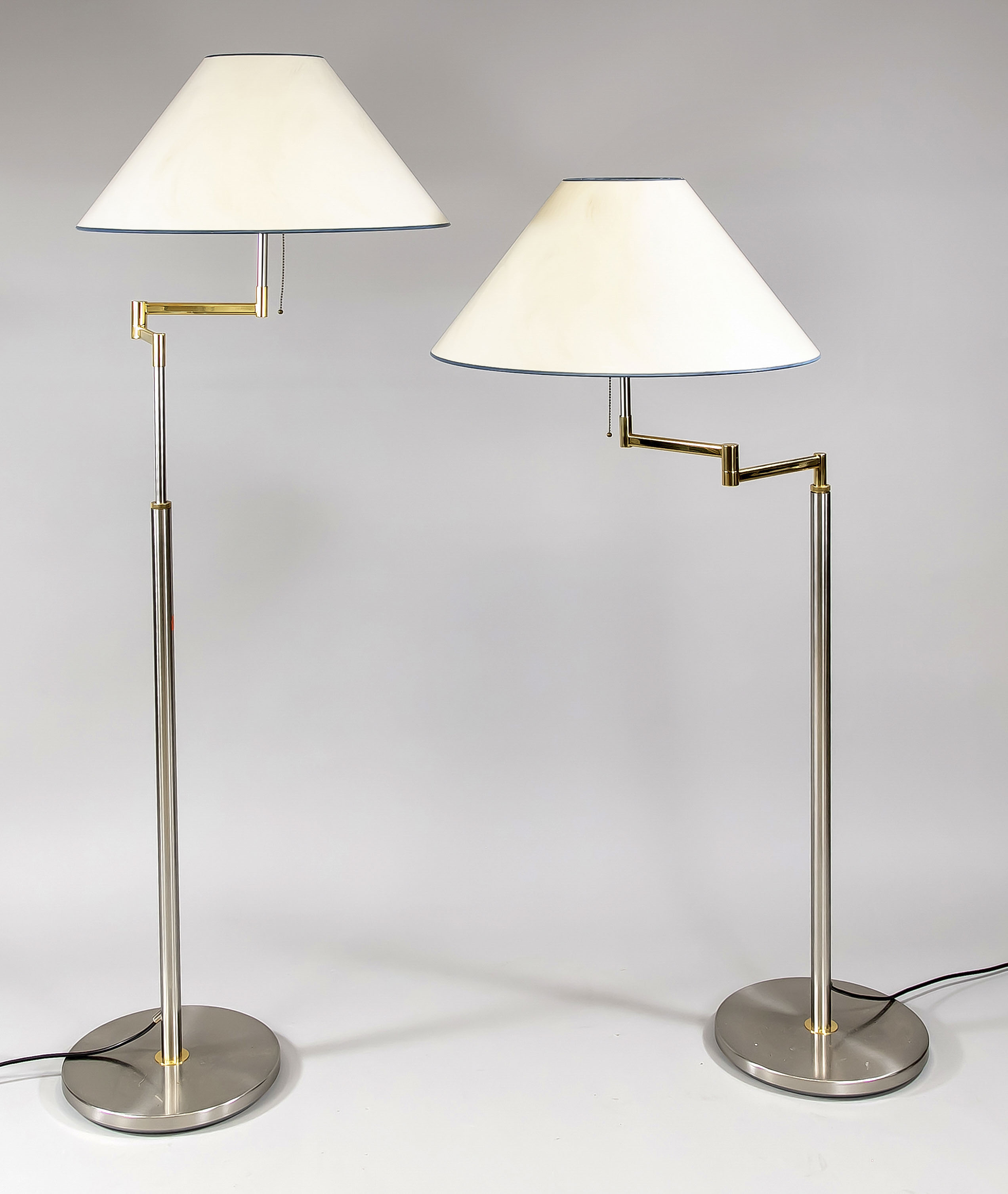 Pair of stainless steel floor lamps with brass, cream fabric lampshades, h. approx. 150 cm, height