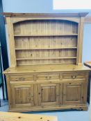 A SOLID PINE TRADITIONAL FARMHOUSE DRESSER - WIDTH 168cm. HEIGHT 200cm.