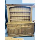 A SOLID PINE TRADITIONAL FARMHOUSE DRESSER - WIDTH 168cm. HEIGHT 200cm.