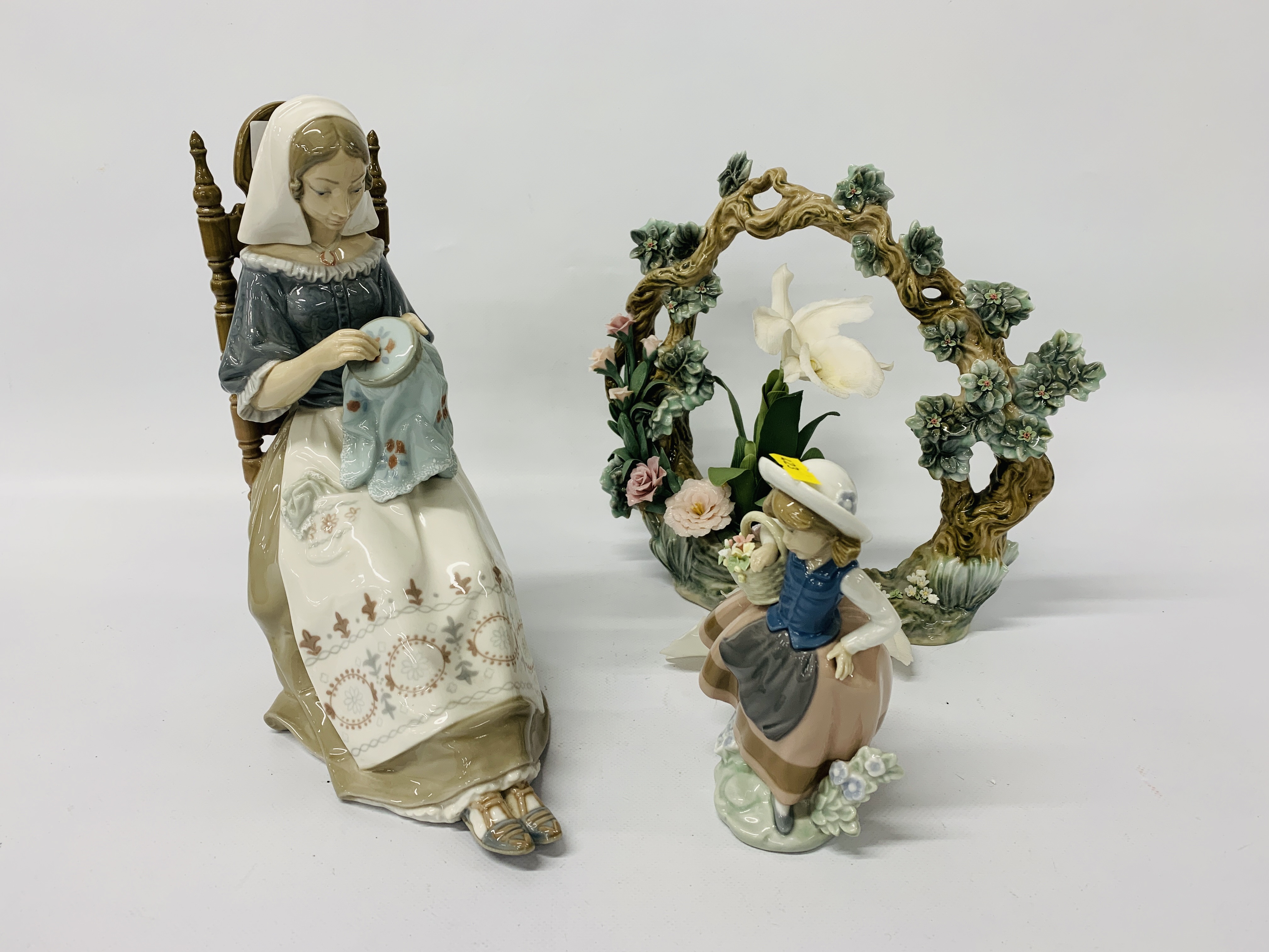 LLADRO FIGURE DOING EMBROIDERY TOGETHER WITH A SMALL LLADRO FIGURE OF A YOUNG GIRL WITH A BASKET OF