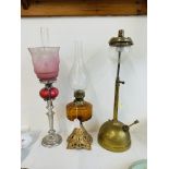 TWO SINGLE BURNER TABLE OIL LAMPS, ONE WITH CRANBERRY GLASS FONT AND ETCHED PINE TO PALE SHADE,