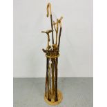 A HAND TURNED STAND CONTAINING A COLLECTION OF WALKING STICKS