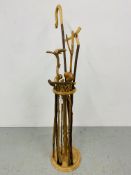 A HAND TURNED STAND CONTAINING A COLLECTION OF WALKING STICKS