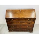 A LARGE ANTIQUE MAHOGANY FOUR DRAWER BUREAU CROSS BANDED DETAILING AND WELL FITTED INTERIOR.