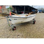 A 10FT FIBREGLASS ROWING DINGHY ON LAUNCHING TRAILER WITH OARS,
