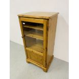 A HONEY PINE PART GLAZED CABINET - WIDTH 59cm. HEIGHT 117cm.