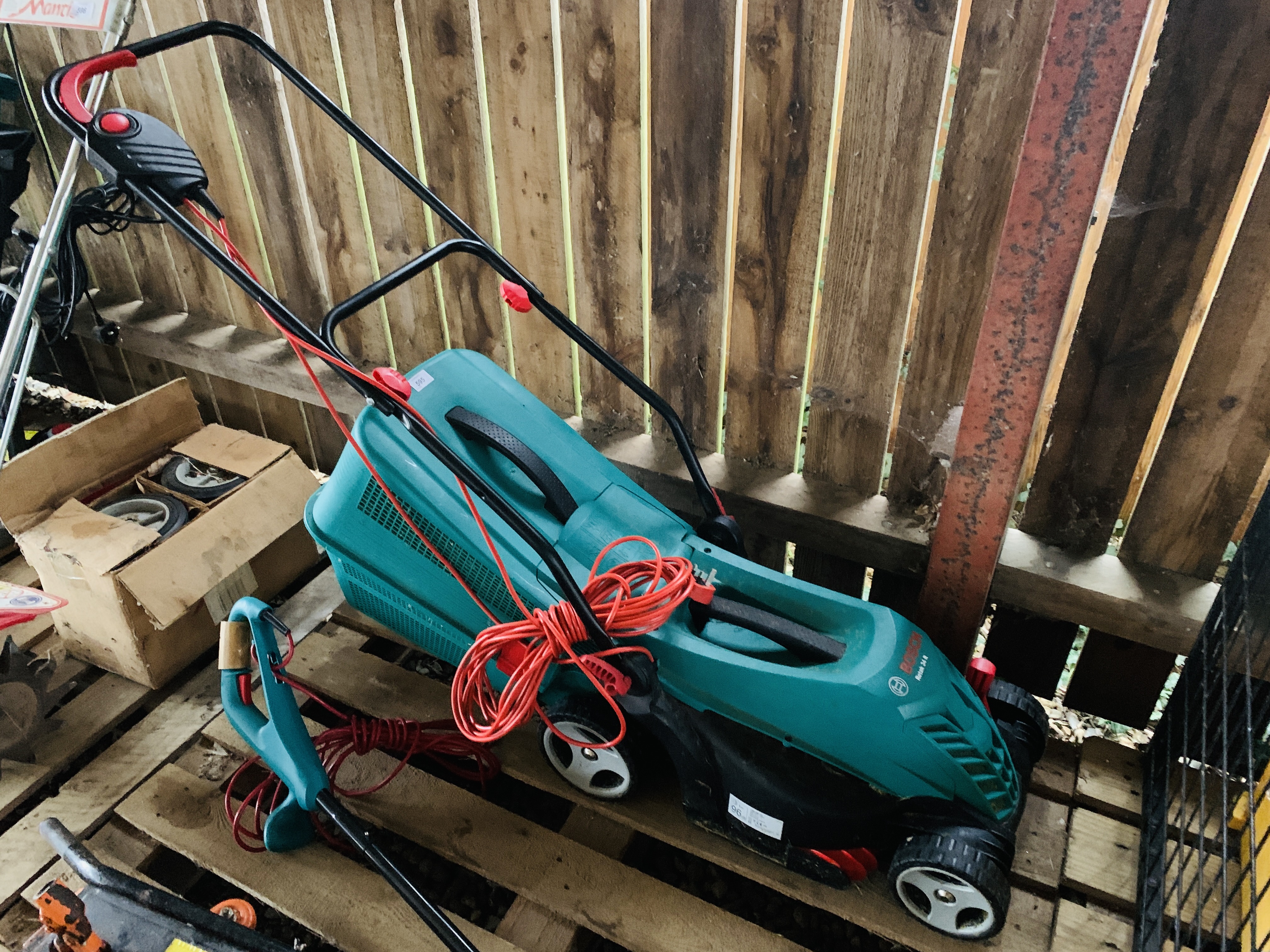 A BOSCH ROTAK 34R ELECTRIC LAWN MOWER AND BOSCH ART 23 SL ELECTRIC STRIMMER - SOLD AS SEEN