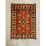 A TURKISH PRAYER RUG, THE MIHRAB OF STEPPED DESIGN ON A GREEN FIELD,