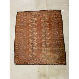 TWO EARLY C20TH TURKOMAN MADDER RED TEKKE RUGS, WITH A FIELD OF GULS ON A LATTICE,