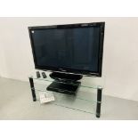 A PANASONIC VIERA 42" FLAT SCREEN TV ON GLASS TV STAND WITH PANASONIC DVD RECORDER MODEL DMR-EZ28