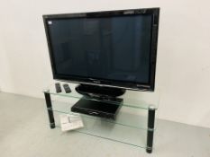 A PANASONIC VIERA 42" FLAT SCREEN TV ON GLASS TV STAND WITH PANASONIC DVD RECORDER MODEL DMR-EZ28