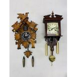 CUCKOO CLOCK TOGETHER WITH A MAHOGANY FINISH "HIGHLANDS" WALL CLOCK