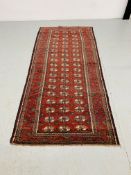 A BALUCHI RED AND BLUE PATTERNED CARPET 2.25 x 1.02. 1.