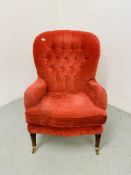 A REPRODUCTION RED VELOUR UPHOLSTERED BUTTON BACK EASY CHAIR