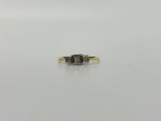 AN 18CT GOLD AND PLATINUM SET THREE STONE DIAMOND RING