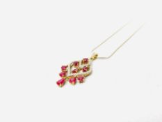 A 9CT GOLD RUBY AND DIAMOND SET PENDANT STRUNG FROM A FINE SILVER NECKLACE