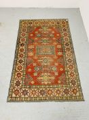 A RED BLUE PATTERNED EASTERN CARPET - W 131CM. L 202CM.