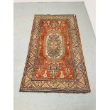 A RED BLUE PATTERNED EASTERN CARPET - W 118CM. L 200CM.