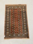 A MAUVE / ORANGE & BLACK PATTERNED EASTERN CARPET - W 96CM. L 145CM.