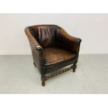 AN ANTIQUE TAN LEATHER UPHOLSTERED TUB CHAIR WITH STUDDED DETAIL AND BARLEY TWIST FRONT STRETCHER