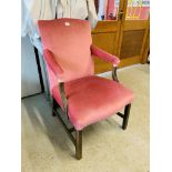 AN ANTIQUE MAHOGANY ELBOW CHAIR WITH PINK VELOUR UPHOLSTERED SEAT AND BACK REST