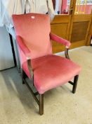 AN ANTIQUE MAHOGANY ELBOW CHAIR WITH PINK VELOUR UPHOLSTERED SEAT AND BACK REST