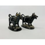 A pair of glazed earthenware cow creamers in Jackfield style,