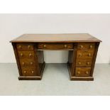 An Edwardian mahogany single piece nine drawer pedestal desk with inlaid tan leather top,