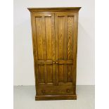 A MODERN OAK TWO DOOR WARDROBE WITH DRAWER BELOW. WIDTH 100cm. HEIGHT 196cm. DEPTH 59cm.