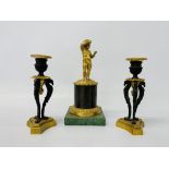 A French C19th gilt metal group of a standing boy and a pair of associated miniature torchères,