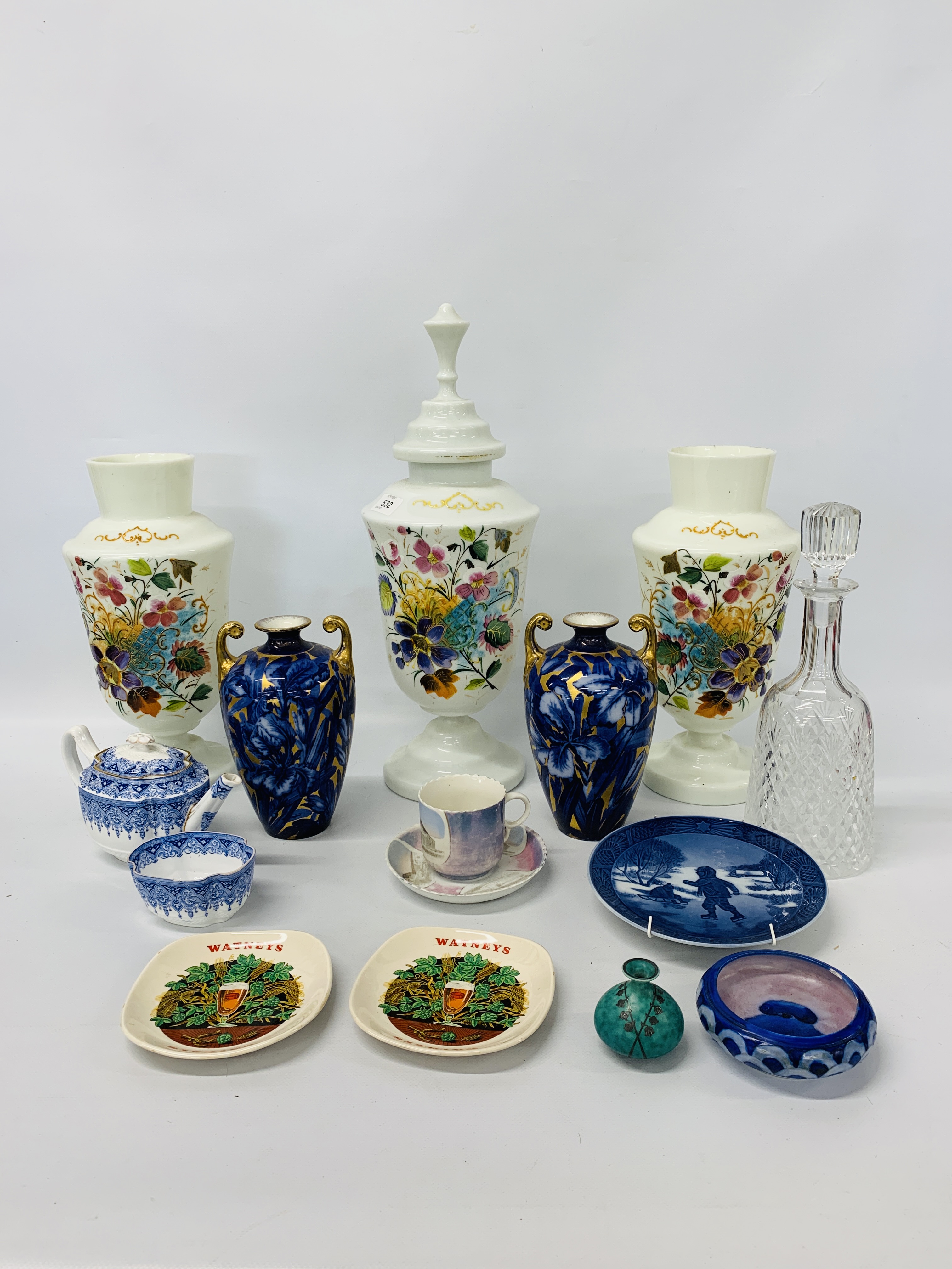 AN OPAQUE GLASS LIDDED VASE AND MATCHING PAIR OF VASES WITH HAND PAINTED FLORAL DECORATION,