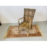 A CANE FRAMED ELBOW CHAIR AND A ROYAL KESHAN RUG 83cm X 160cm.