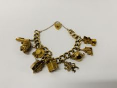 A 9CT GOLD CHARM BRACELET WITH SAFETY CHAIN AND PADLOCK CLASP.
