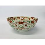A Chinese polychrome punch bowl, decorated in red and green enamels with flowers, probably Qianlong,