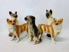 A pair of china models of dogs along with a model of a seated spaniel (A/F),