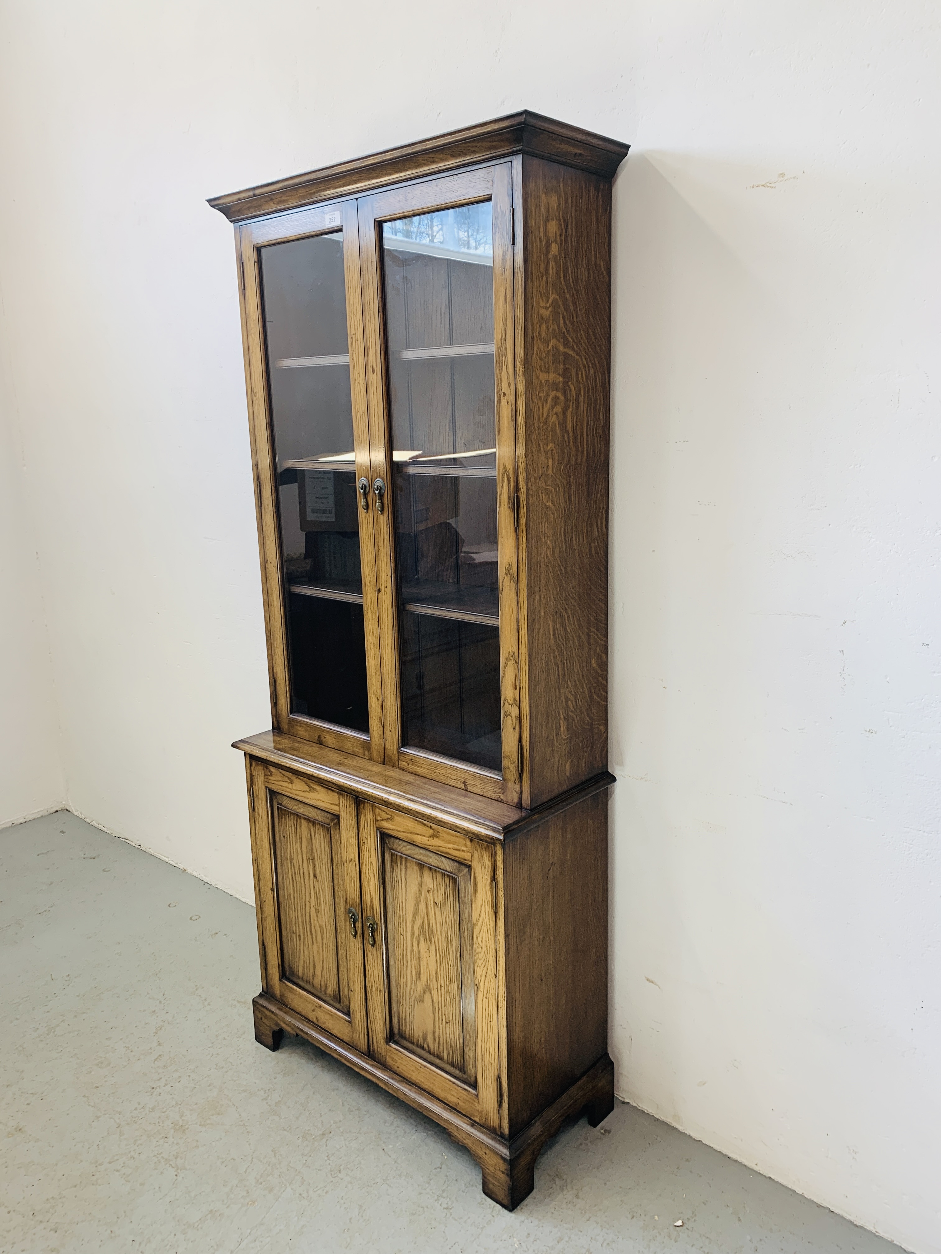 A QUALITY REPRODUCTION OAK BOOKCASE WITH CUPBOARD BASE BY DAVID NOTTAGE CABINET MAKER - W 75cm. - Image 2 of 14