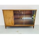 A McINTOSH VINTAGE TEAK SLIDING DOOR BOOKCASE WITH CABINET TO END.