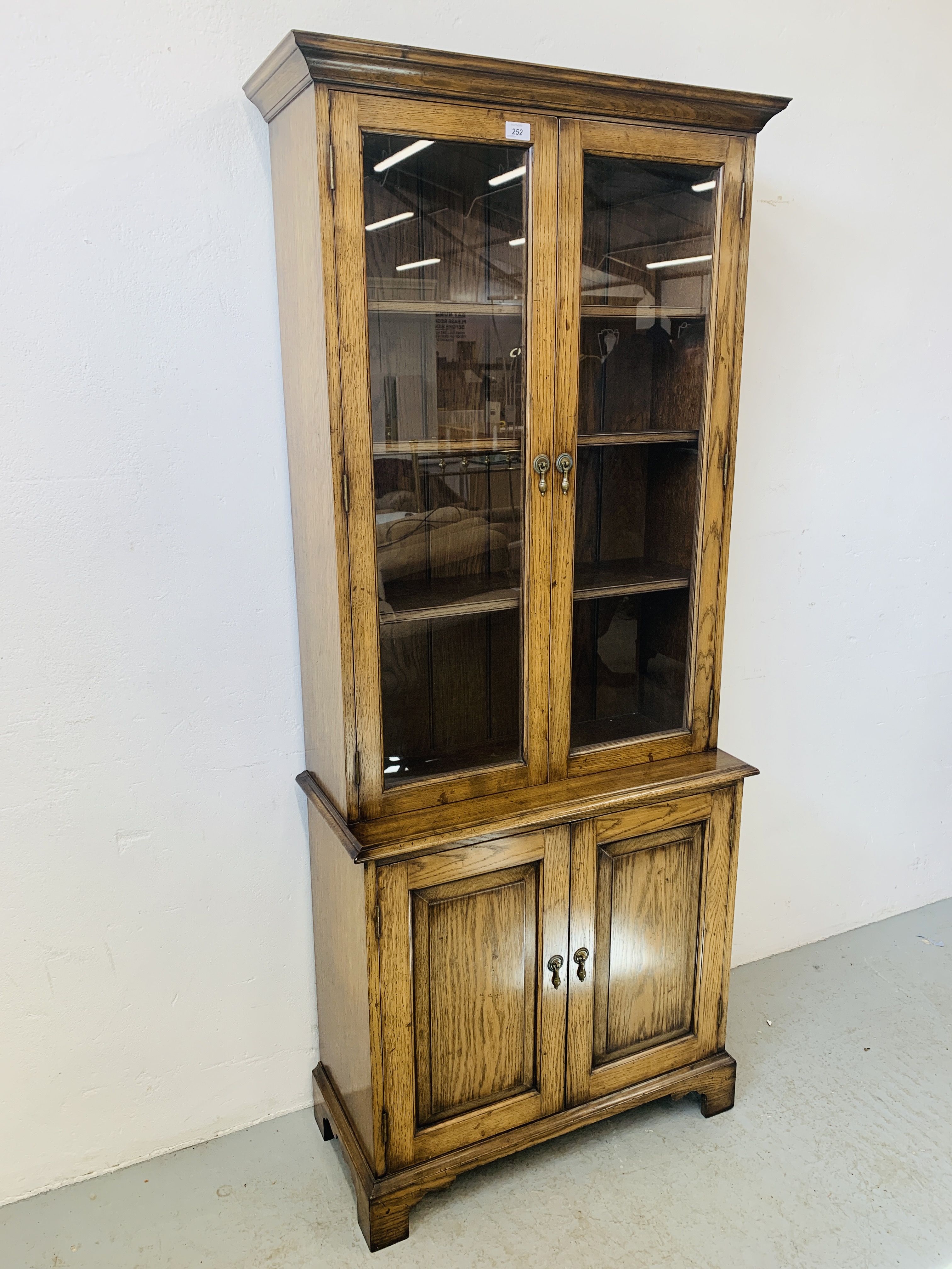 A QUALITY REPRODUCTION OAK BOOKCASE WITH CUPBOARD BASE BY DAVID NOTTAGE CABINET MAKER - W 75cm. - Image 3 of 14