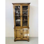 A QUALITY REPRODUCTION OAK BOOKCASE WITH CUPBOARD BASE BY DAVID NOTTAGE CABINET MAKER - W 75cm.