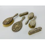 Six pieces of silver mounted toilet items including a brush and mirror en-suite,