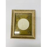 A framed wax medallion of classical figures,