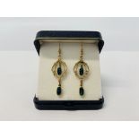 A PAIR OF 9CT GOLD DROP EARRINGS EACH SET WITH TWO OVAL OPALS.