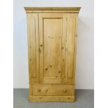 AN ANTIQUE STRIPPED AND WAXED PINE WARDROBE WITH DRAWER TO BASE - W 106CM. H 196CM. D 47CM.