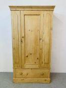 AN ANTIQUE STRIPPED AND WAXED PINE WARDROBE WITH DRAWER TO BASE - W 106CM. H 196CM. D 47CM.