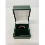 A 9CT GOLD THREE STONE RUBY RING WITH DIAMOND SET SHOULDERS