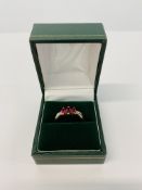 A 9CT GOLD THREE STONE RUBY RING WITH DIAMOND SET SHOULDERS