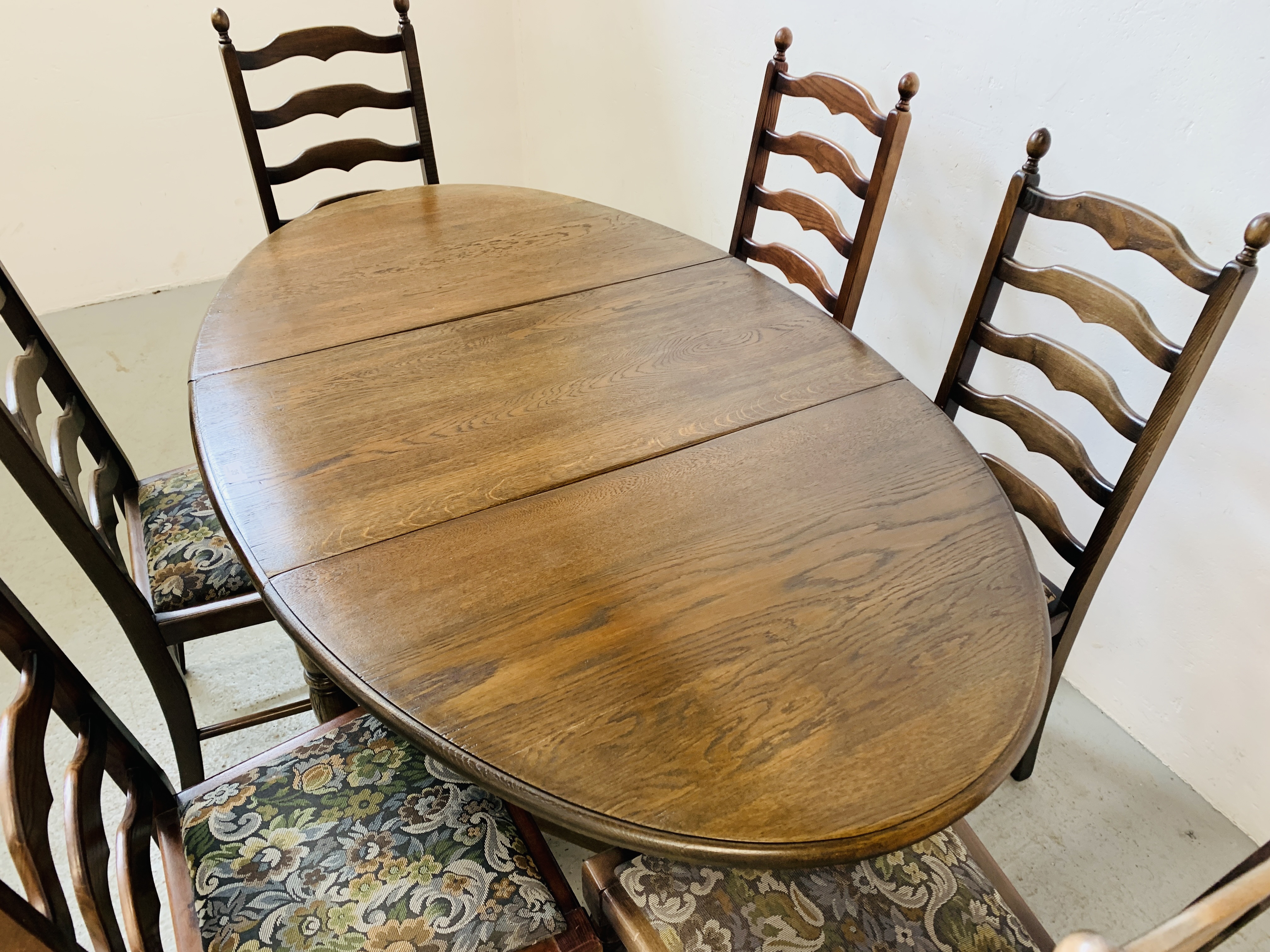 AN OVAL TOP OAK GATELEG DINING TABLE EXTENDED 152 X 91CM ALONG WITH A SET OF SIX LADDER BACK DINING - Image 4 of 12