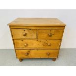 A COUNTRY PINE TWO OVER TWO CHEST OF DRAWERS STANDING ON TURNED FEET - W 81CM. H 79CM. D 44CM.