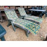 A PAIR OF GREEN UPVC FOLDING GARDEN SUN CHAIRS COMPLETE WITH CUSHIONS