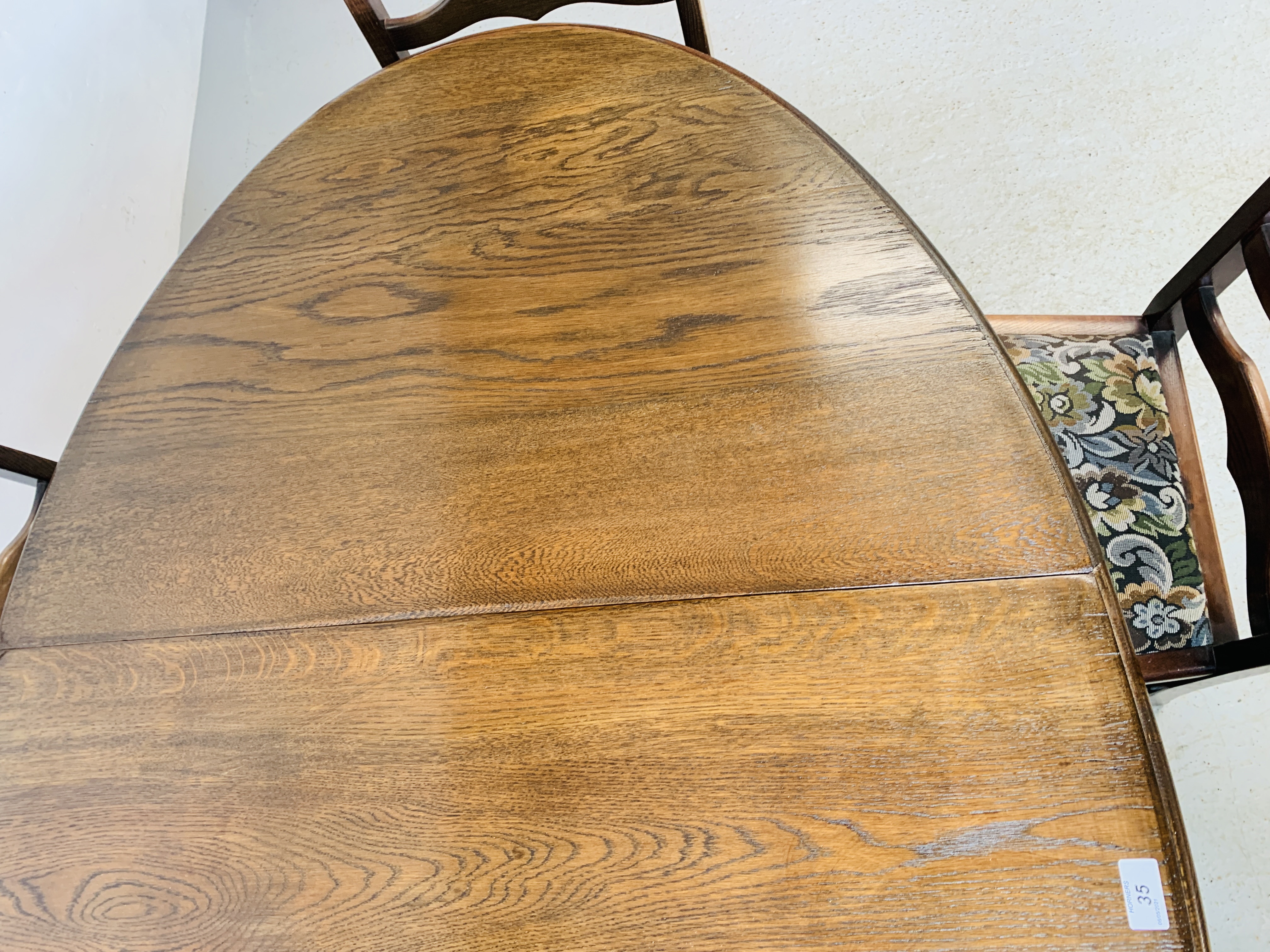 AN OVAL TOP OAK GATELEG DINING TABLE EXTENDED 152 X 91CM ALONG WITH A SET OF SIX LADDER BACK DINING - Image 12 of 12